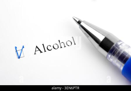 Alcohol. Filling in the questionnaire, documents. The checkboxes are filled with a black pen on a white background. Questionnaire, survey. Stock Photo