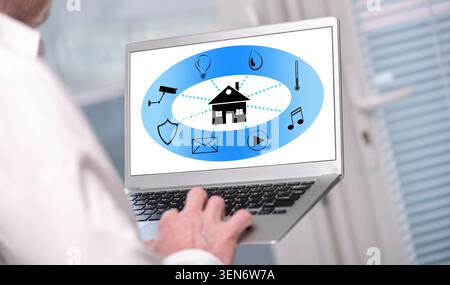 Smart home automation concept shown on a laptop used by a man Stock Photo