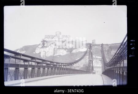 Château-Gaillard and a bridge at Les Andelys appear in a 1929 photograph by Marcel Maillard. The press photograph records the fortified castle in Eure, France, placing the medieval stronghold within its surrounding landscape and crossing point. Stock Photo
