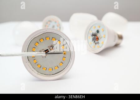Disassembled LED lamp with one light emitting diode chip burnt out. Burnt out LED in the lamp. Stock Photo