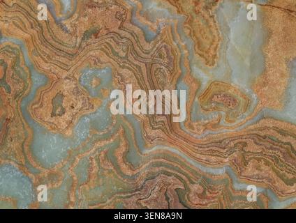 Slab of rainbow onyx,  colors are brown and ochre alterning with pale green and off white . Full frame, background and texture. Stock Photo