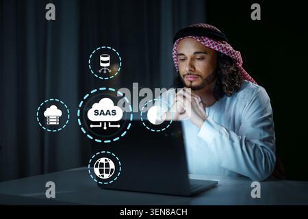 Person using laptop to explore software as a service solutions at night Stock Photo