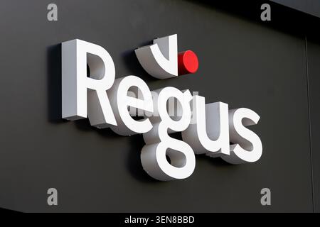 Sign outside a Regus facility. Regus is a brand of IWG (International Workplace Group), multinational company offering serviced offices and coworking Stock Photo