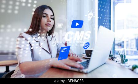 Woman using computer to manage content in a system at a modern workspace Stock Photo