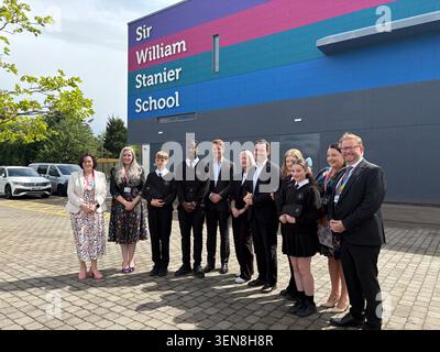 Esther Ghey (centre) the mother of murdered teenager Brianna Ghey, joins the Duke of Westminster Hugh Grosvenor and Cheshire Police and Crime Commissioner Dan Price (fifth right) on a visit to Sir William Stanier school in Crewe, as it becomes one of the latest in Cheshire to introduce the signal-blocking pouches, which are locked after pupils place their phones into them at the start of the day. The mother of murdered teenager Brianna Ghey said it felt emotional to see "positive change" as she visited a school which has introduced lockable pouches to stop students using their phones during th Stock Photo