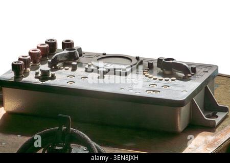 Vintage industrial control panel featuring metal knobs and dials showcasing robust construction, worn texture, circular components, numerical markings Stock Photo
