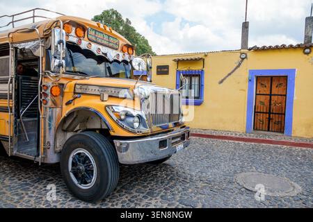 San Juan del Obispo Guatemala,Antigua Guatemala,traditional chicken bus,public transportation,International bus,colorful vehicle,cobblestone street,lo Stock Photo