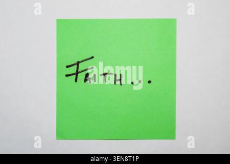The word faith on a green Post-it sticker Stock Photo