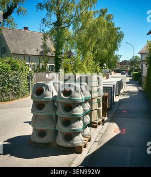 Concrete pipe fittings for road repair placed near a work site Stock Photo