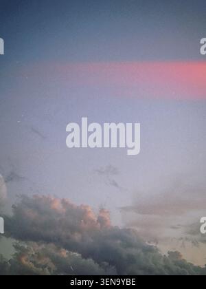 Pink and grey cloud formations at dusk over Austin, Texas, USA. Stock Photo