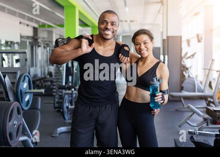 Black standing together in gym with bag and water after training Stock Photo