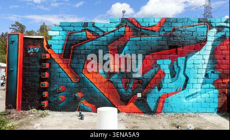 Stockholm, Sweden, may 17, 2026. A vibrant abstract graffiti mural painted in red, turquoise and black across a brick wall, showing bold geometric sha Stock Photo