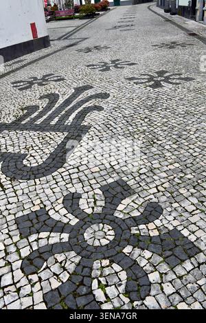 Handlaid black and white stones in street of Azores, Portugal. Details from street surface with basalt and volcanic stone tiles laid in beautiful patt Stock Photo