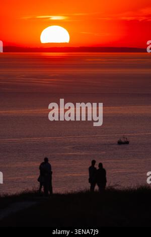 Scenic sunset glow over calm water of Lake Constance Bodensee with ...