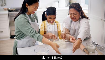 Baking, grandmother, mother with girl in kitchen, teaching culinary skills and meal prep assistance. Happy, women or child with dough for cooking Stock Photo