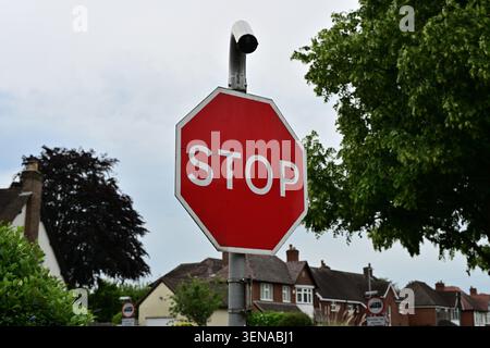 Stop sign with surveillance camera in quiet suburban neighborhood Stock Photo