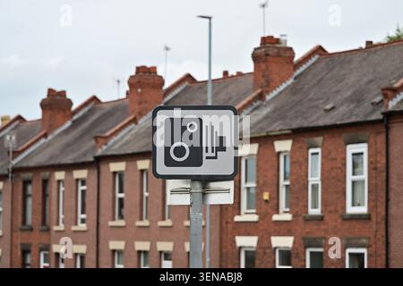 Speed camera warning sign on pole in residential street Stock Photo