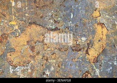 Weathered rusty metal surface texture closeup. Industrial background showing corrosion, peeling paint and material aging. Stock Photo