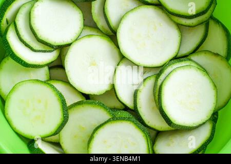 Zucchini slices in a bowl, close-up, top view Stock Photo