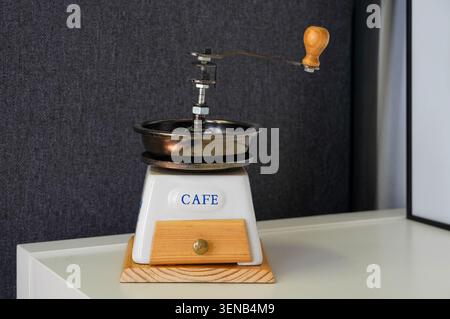 Coffee grinder with the word coffee on a white table Stock Photo