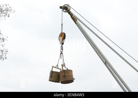 Crane hook with bucket, close-up, low angle view Stock Photo