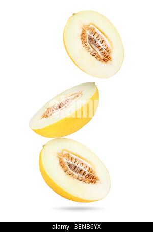 Sweet melon halves falling against white background Stock Photo