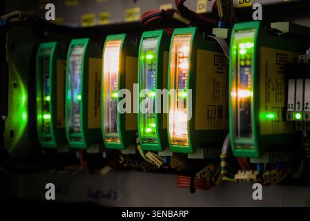 Conceptual close up of glowing LED indication on modular electronic components inside automation control system Stock Photo