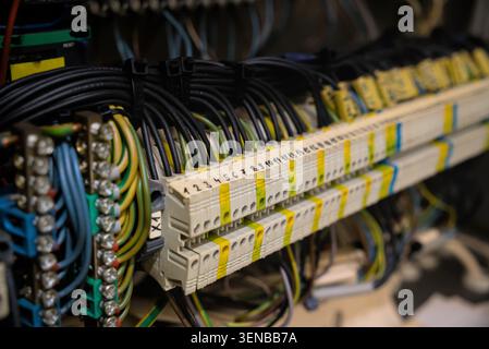 Close-up of industrial electrical terminal block with numbered wire connections in control cabinet Stock Photo