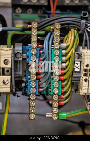 Industrial control panel wiring with terminal blocks and copper busbars Stock Photo