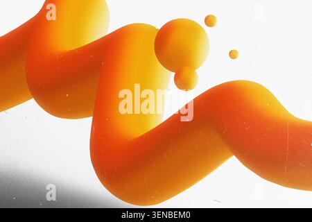 3D abstract fluid shape with orange and yellow gradient and floating spheres on white textured background Stock Photo