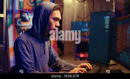 Hacker excited after finally developing zero day exploit undetectable by antivirus software installed on systems, Rogue programmer happy to successfully trick firewalls, close-up. Stock Photo