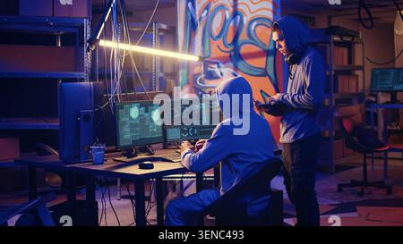 Spies in secret hideout trying to steal valuable data by hacking governmental websites but getting their attacks rejected by strong security, seeing access denied error message on screen. Stock Photo