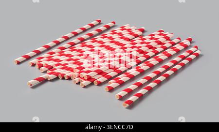 red and white striped paper straws isolated grey background, disposable drinking tubes with spiral pattern, angle view with shadows Stock Photo