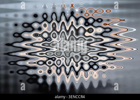 Abstract radial fluid art with mandala pattern in black grey beige and brown tones on silver background decorative fine art Stock Photo