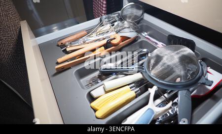 Kitchen drawer with various utensils and tools for cooking Stock Photo