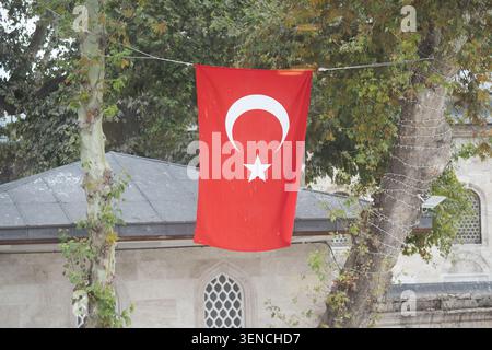 Turkish flag hanging near a building in daylight Stock Photo