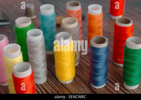 Colorful Sewing Thread Spools On Wooden Table Stock Photo