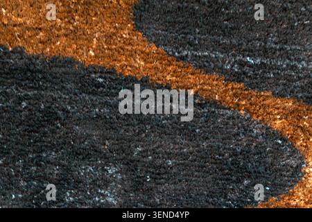 Closeup abstract fabric texture with dark and brown tones showing soft fibers rough surface and organic pattern suitable for backgrounds textile and d Stock Photo
