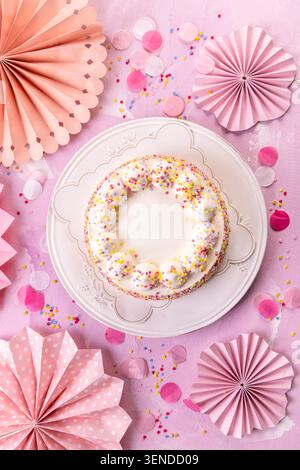 Delicious Cream cake for birthday party with pink paper decorations Stock Photo