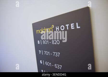 Maldron Hotel room sign with copy space. Modern hotel signage yellow and white on grey with room numbers. Stock Photo