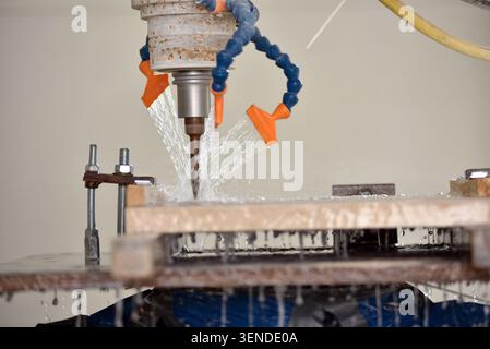 Robot working on milling sculpture in natural stone Stock Photo
