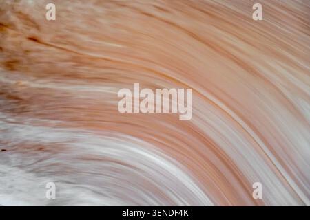 Abstract natural stone texture with flowing organic layers in warm beige and cream tones, elegant mineral background for luxury interior design Stock Photo