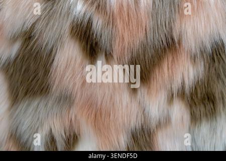 Luxury multicolor faux fur texture background in pastel tones, soft fluffy animal print fabric close up Stock Photo