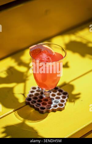 Grapefruit cocktail on bright yellow table Stock Photo