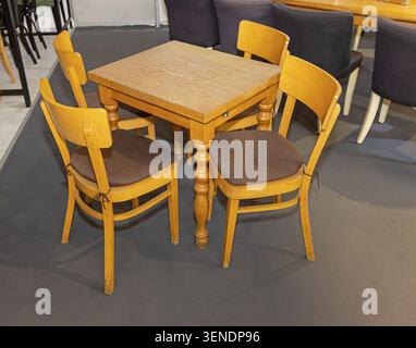 Old Style Wooden Chairs and Square Dining Table Set Stock Photo