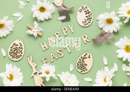 Easter background with white chrysanthemums flowers, colored eggs and decorations on color background with text Stock Photo