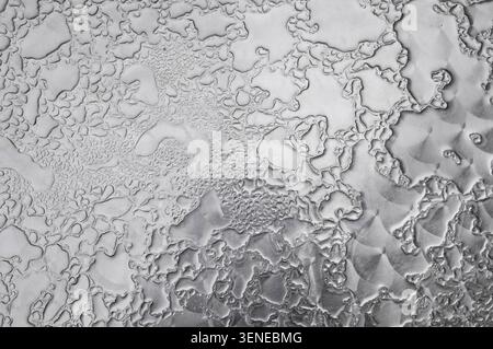 rain drops on patterned metal cafe table top, yorkshire, england Stock Photo