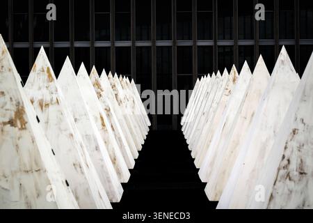 Symmetrical rows of geometric pyramid structures in an urban setting Stock Photo