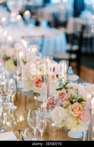 Elegant wedding reception table with floral arrangements Stock Photo