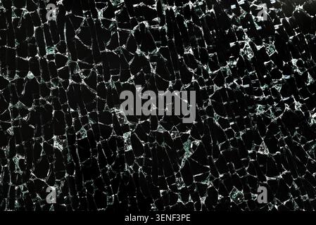 Shattered tempered glass texture on a black background. Abstract cracked pattern suitable for overlay, background, design and graphic projects. Stock Photo
